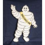 A Michelin man shaped cast iron plaque