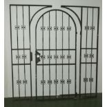 A large wrought iron garden gate with two side panels