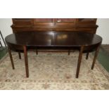 A mahogany extending dining table with two leaves