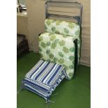 A garden lounger, chair cushions and a laundry clothes airer