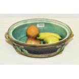 A majolica tureen base and four pottery pieces of fruit