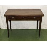 A mahogany fold over top tea table with drawer and string inlays.