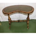 A Victorian walnut kidney shaped table with leather insert. Very good condition.