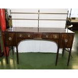 A Georgian mahogany sideboard with brass back rail.