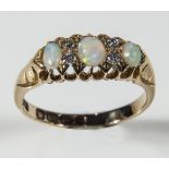 A lady's 18ct gold ring set with three opals and diamonds, weight 3gms, size P