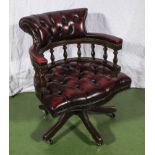 A swivel desk chair mahogany and leather.