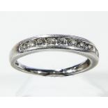 A lady's platinum channel ring set with diamonds, weight 4gms, size Q