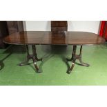 An Edwardian mahogany dining table with one extra leaf