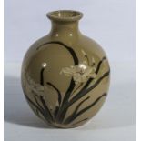 A Japanese pottery vase decorated with foliage