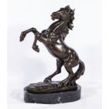 A rearing bronze horse on a marble base