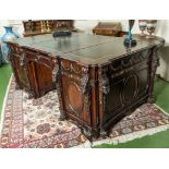 A mahogany library desk, after a design by Thomas Chippendale. The green leather writing surface