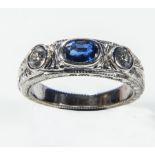 A lady's 18ct white gold ring set with a sapphire and diamonds, weight 6gms, size M