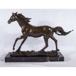 A large bronze horse on marble base