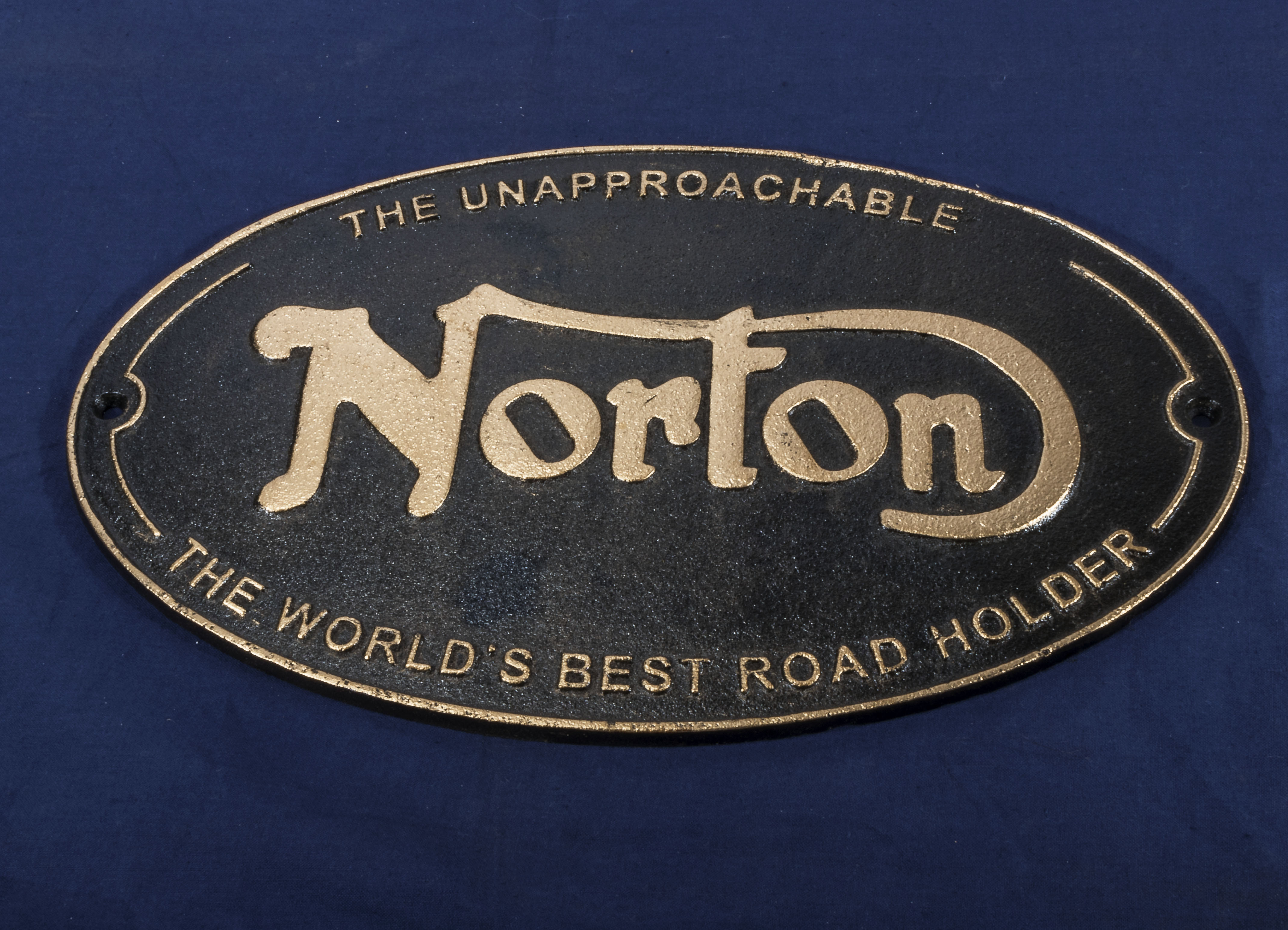 Norton black and gold plaque