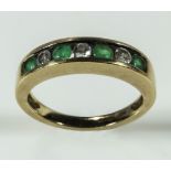 A lady's 18ct gold channel ring set with emeralds and diamonds, weight 4gms, size L
