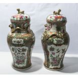 A pair of Chinese Qing period Canton famille rose lidded vases, 39cm tall