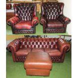 A leather Chesterfield sofa, two armchairs and a foot stool
