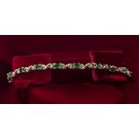 A 9ct gold bracelet set with emeralds and diamonds, weight 5gms