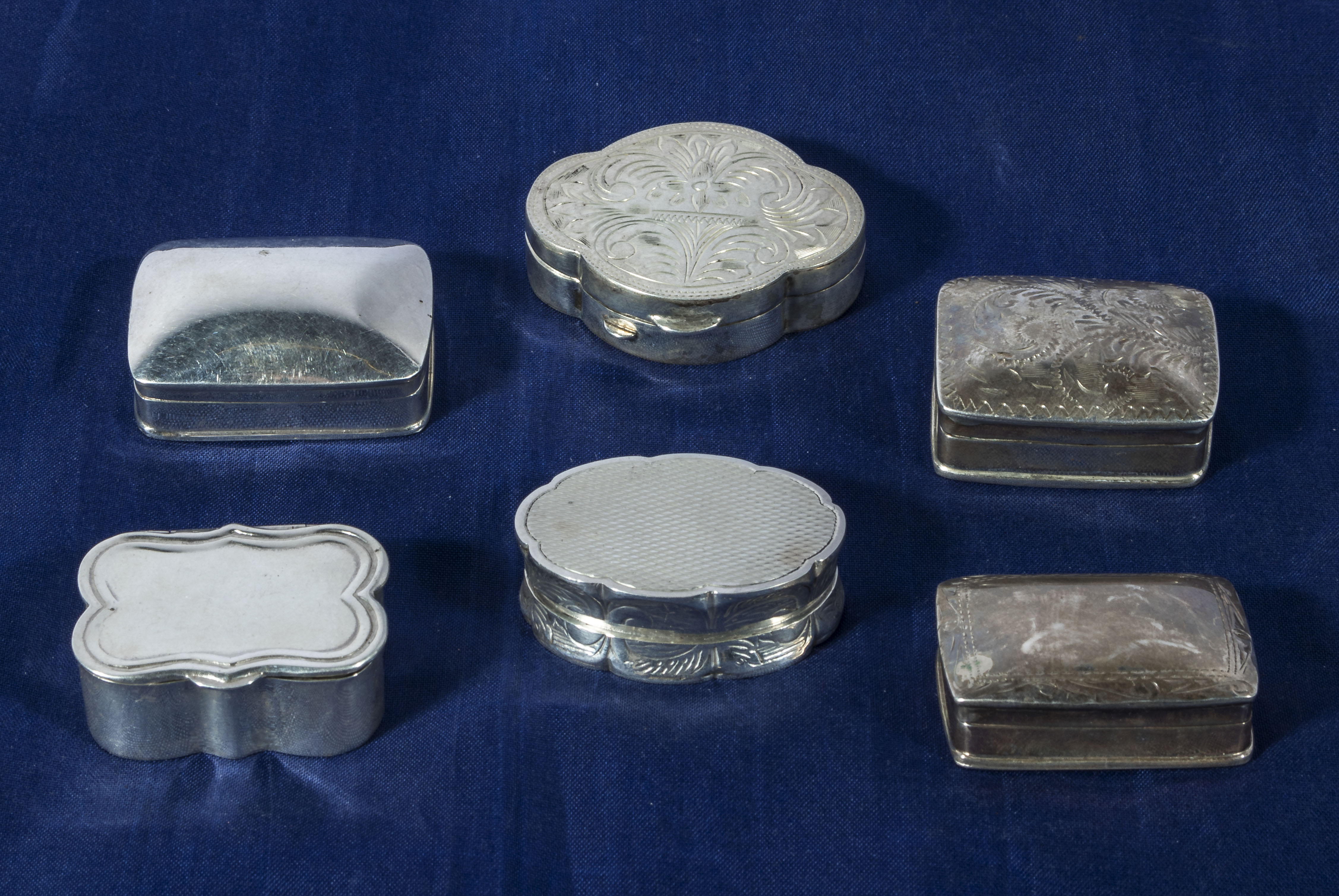 Six silver pill boxes