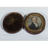 An early 19th century miniature of a gentleman in an oval gilt and leather case
