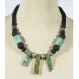 Unique designer necklace, green Italian glass, lava rock and titanium quartz