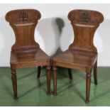 A pair of Victorian mahogany hall chairs.