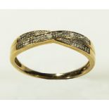 A lady's 9ct gold diamond twist ring, size M