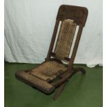 An Anglo Indian carved teak folding campaign chair