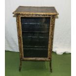 A bamboo cabinet with glazed door