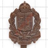 Kensington VTC WW1 scarce bronze cap badge. Die-cast crowned laurel sprays on tri-part scroll “