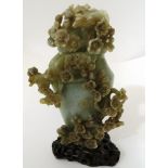 A Chinese carved jade vase and cover decorated in high relief with birds on a blossoming branch,