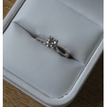 A platinum and diamond solitaire ring in a Preston and Duckworth ring box