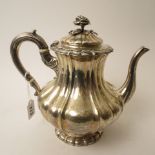 William 1V silver teapot, moulded fluted decoration on a circular foot, rose finial to lid, London