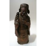 A Chinese carved bamboo figurine of an immortal, 10 6/8 high