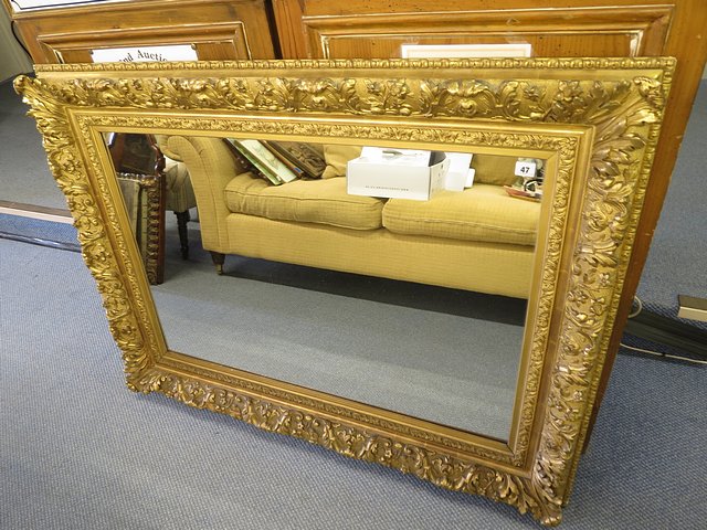 A 19th century gilt gesso wood mirror with moulded acanthus leaf and floral decoration, later