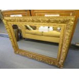 A 19th century gilt gesso wood mirror with moulded acanthus leaf and floral decoration, later