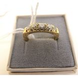 An 18ct gold ring set with five graduated diamonds