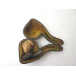 A cased Meerschaum pipe carved with the head of a man wearing a hat