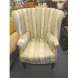 A George III upholstered, curved back armchair on mahogany turned, tapered legs, 44 1/2 high x 30