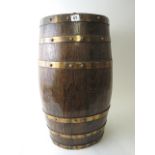 An early 20th century oak stick stand fashioned as a barrel with brass bands, 25.5 high