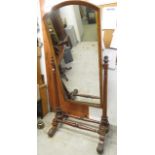 A large Victorian mahogany cheval mirror with arched plate glass and carved decoration, frame 52
