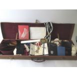 An early 20th century canvas and leather case containing Masonic regalia, to include a cased