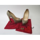 A pair of Christian Louboutin high heel, gold glitter shoes, size 40 with original dust covers and