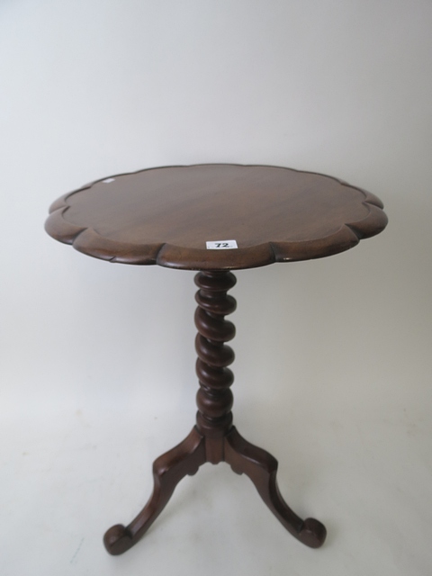 A 19th century mahogany canted topped wine table on a barley twist central support, standing on