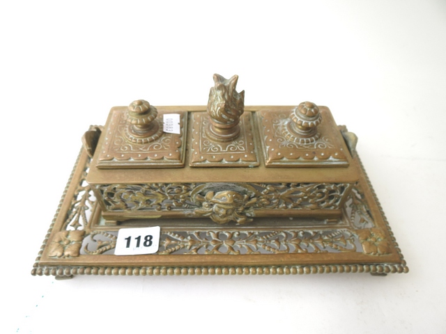 A 19th century brass desk stand of rectangular form fitted with two glass inkwells on four feet,