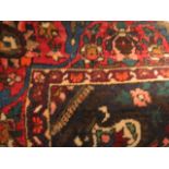 A Persian carpet with a central medallion and flora on a red ground, 80 x 120