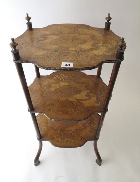 A French three tier inlaid étagère with gilt brass finials and shelf edges, on splayed hoof feet,