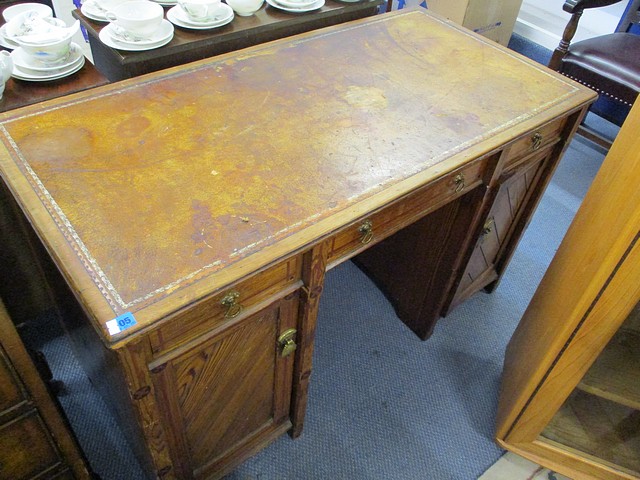 A late Victorian Maple & Co pitch pine twin pedestal desk, 28 1/2 x 47
