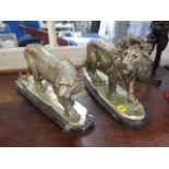 A pair of silvered models, a lion and a lioness on marble stands, 12 x 19