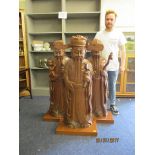 Three 20th century elm carved Oriental figures on later plinth bases, 48 high
